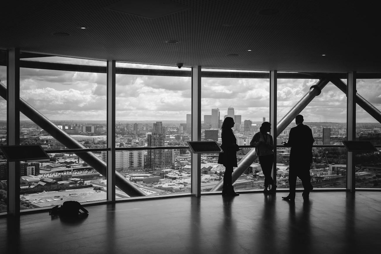 Executives in discussion overlooking a city skyline